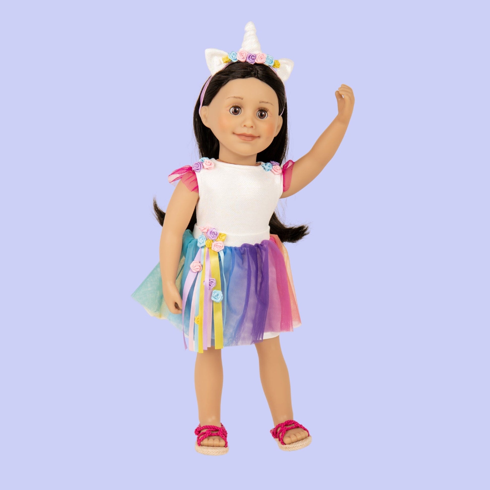 18 inch doll wearing a unicorn outfit of white body suit, multicolour tutu and a unicorn headband