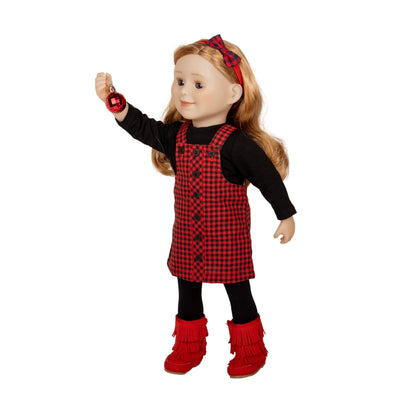 Doll in lumberjack plaid jumper hanging a christmas ornament.  Doll is wearing red fringe boots.