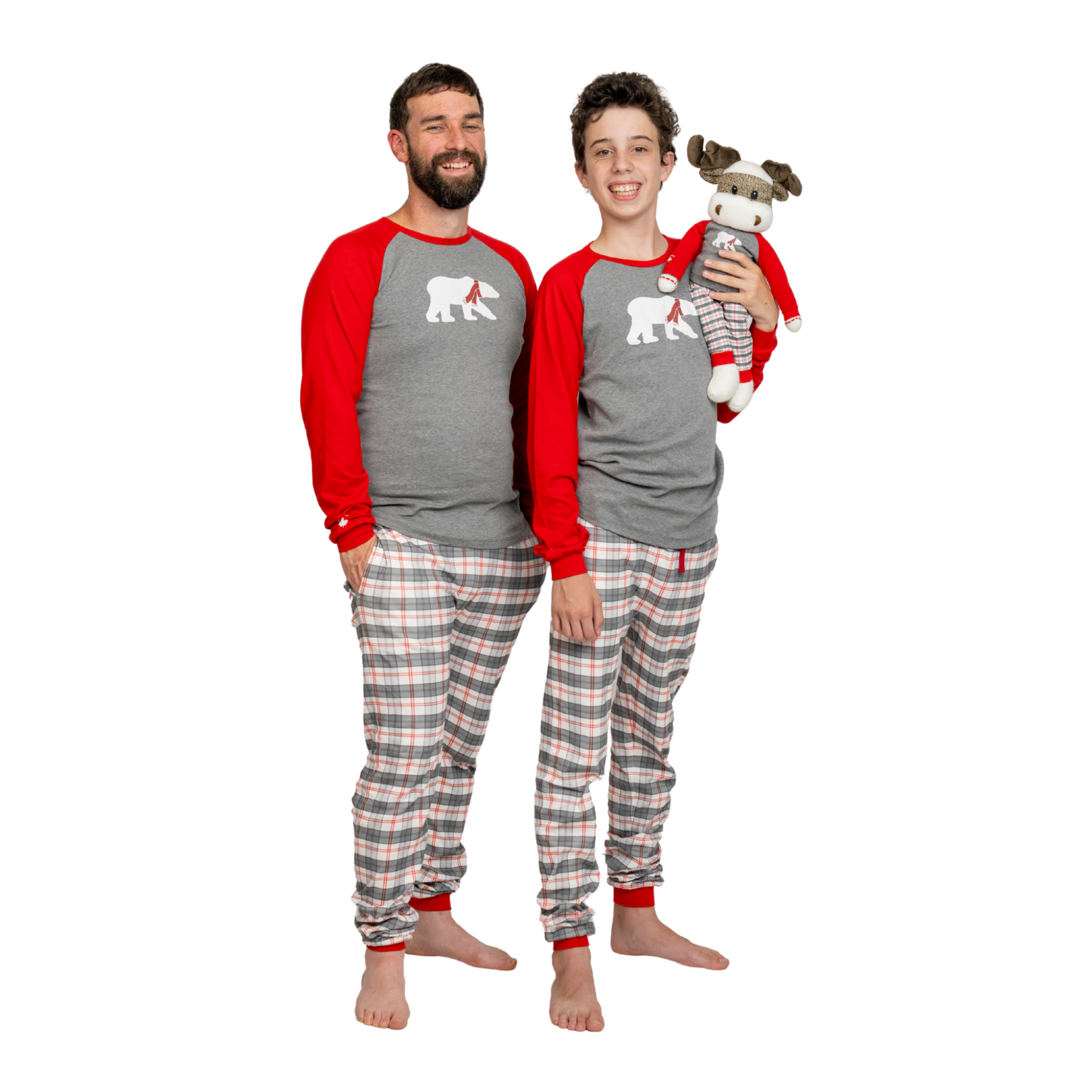 Two people wearing matching red and grey polar bear pajamas.
