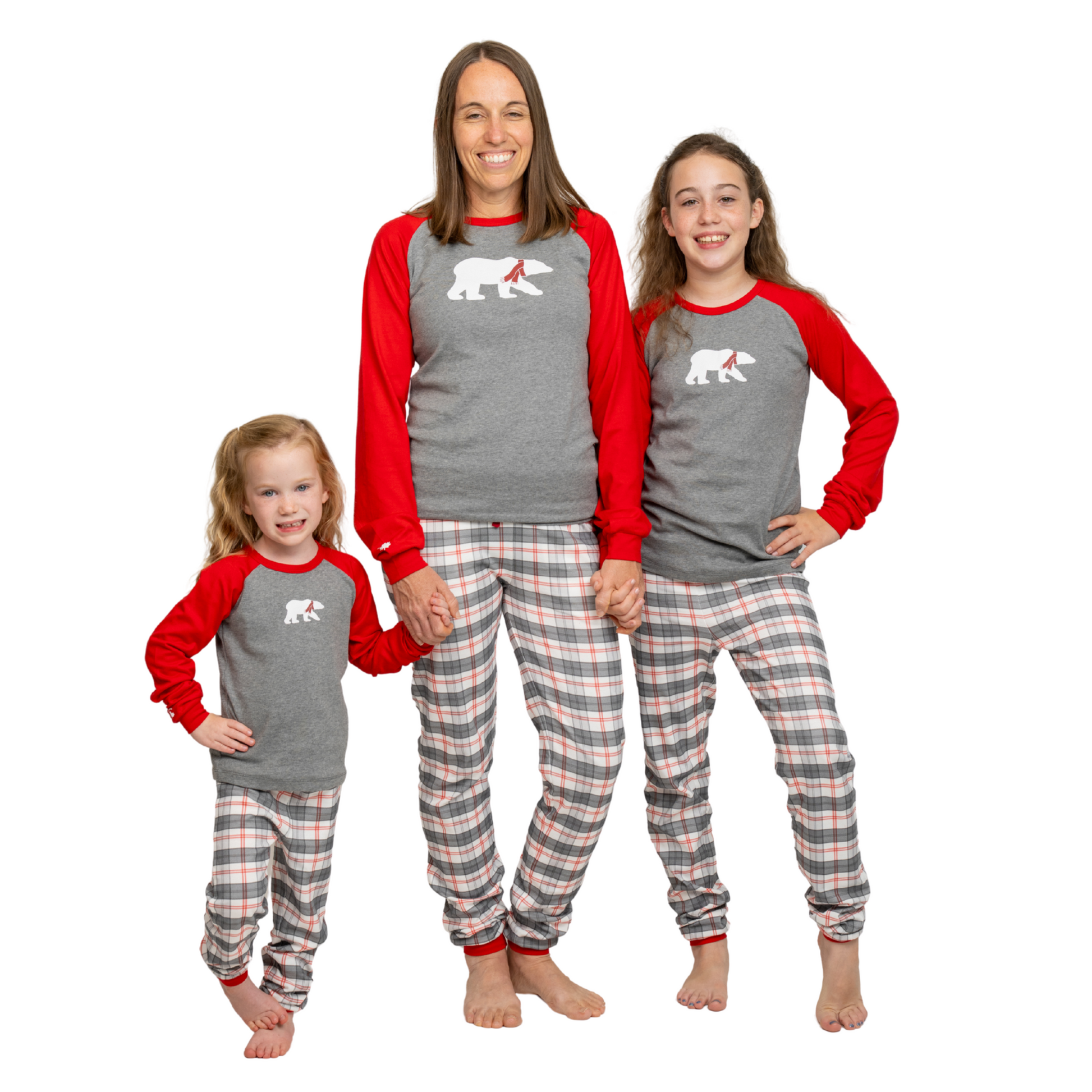 Mom and daughters wearing matching pajamas with a  polar bear on the front.