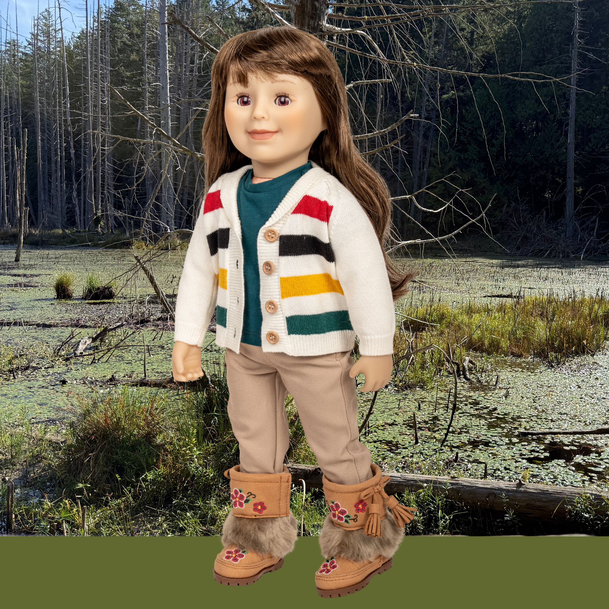 18-inch doll wearing a colorful striped cardigan and fur-trimmed boots in a natural forest setting in Canada.