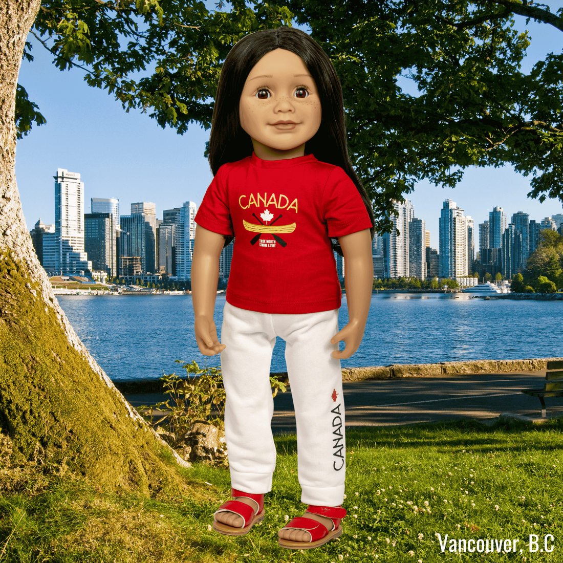 Two 18-inch dolls wearing a red 'Canada' t-shirt with white pants and red shoes.