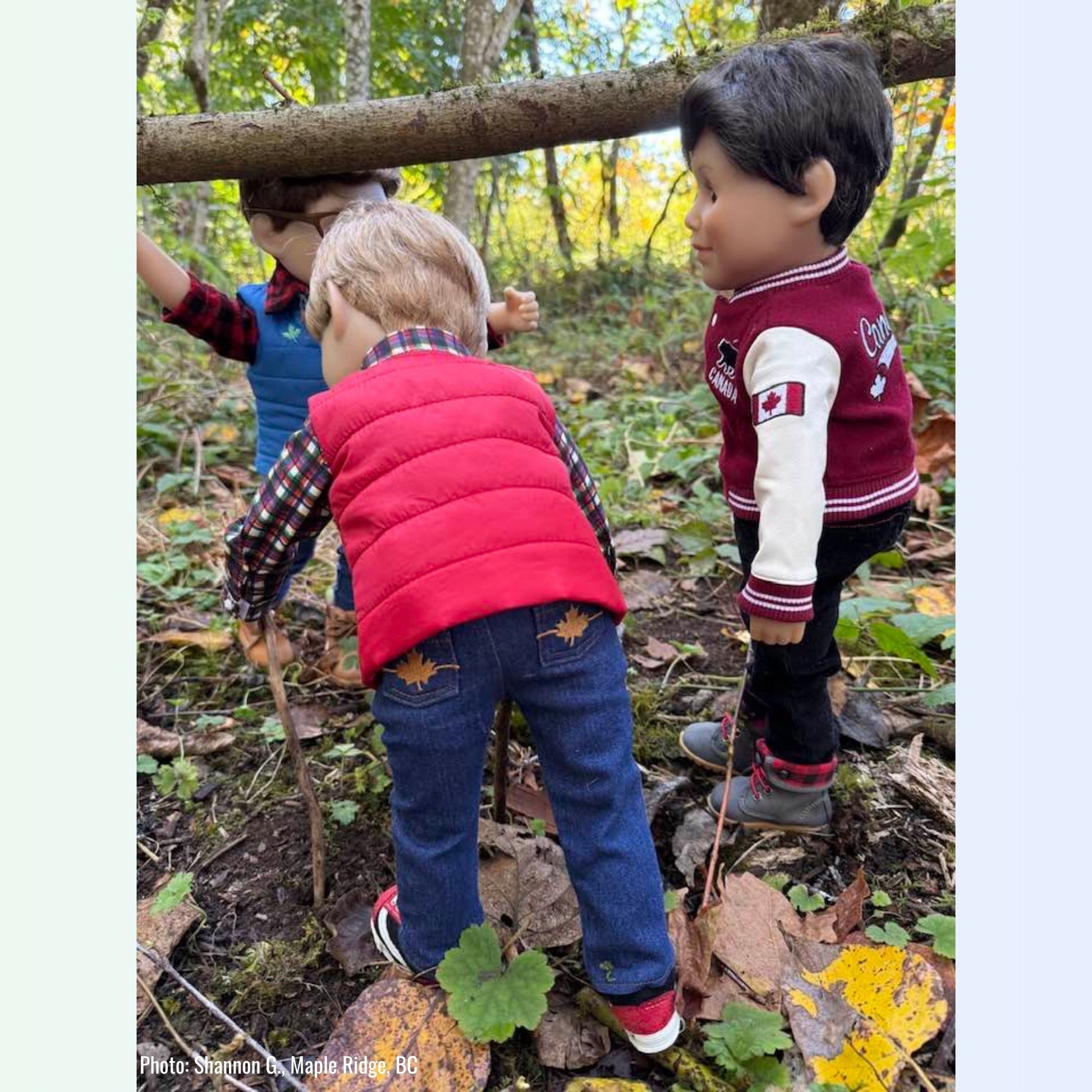 18-inch boy dolls playing in a forest wearing Fall Foliage outfit with puffer vest and Bear Track Canadian jacket and Grey Jay hiking boots