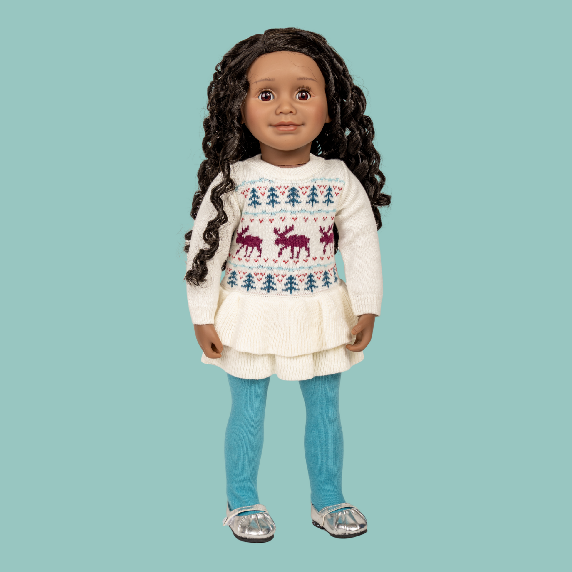 18-inch doll wearing knitted moose pattern sweater dress and blue tights with silver shoes.