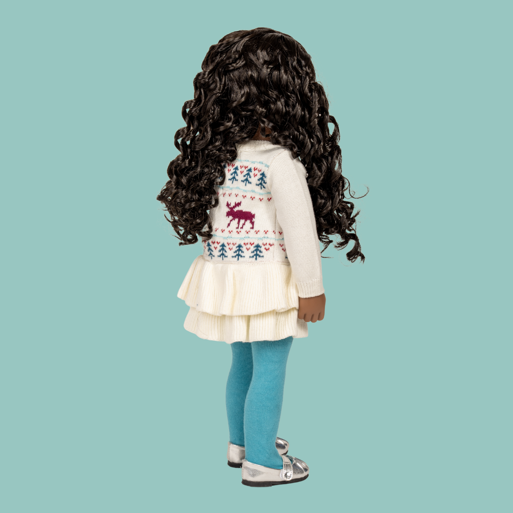 18-inch doll wearing knitted moose pattern sweater dress and blue tights with silver shoes.