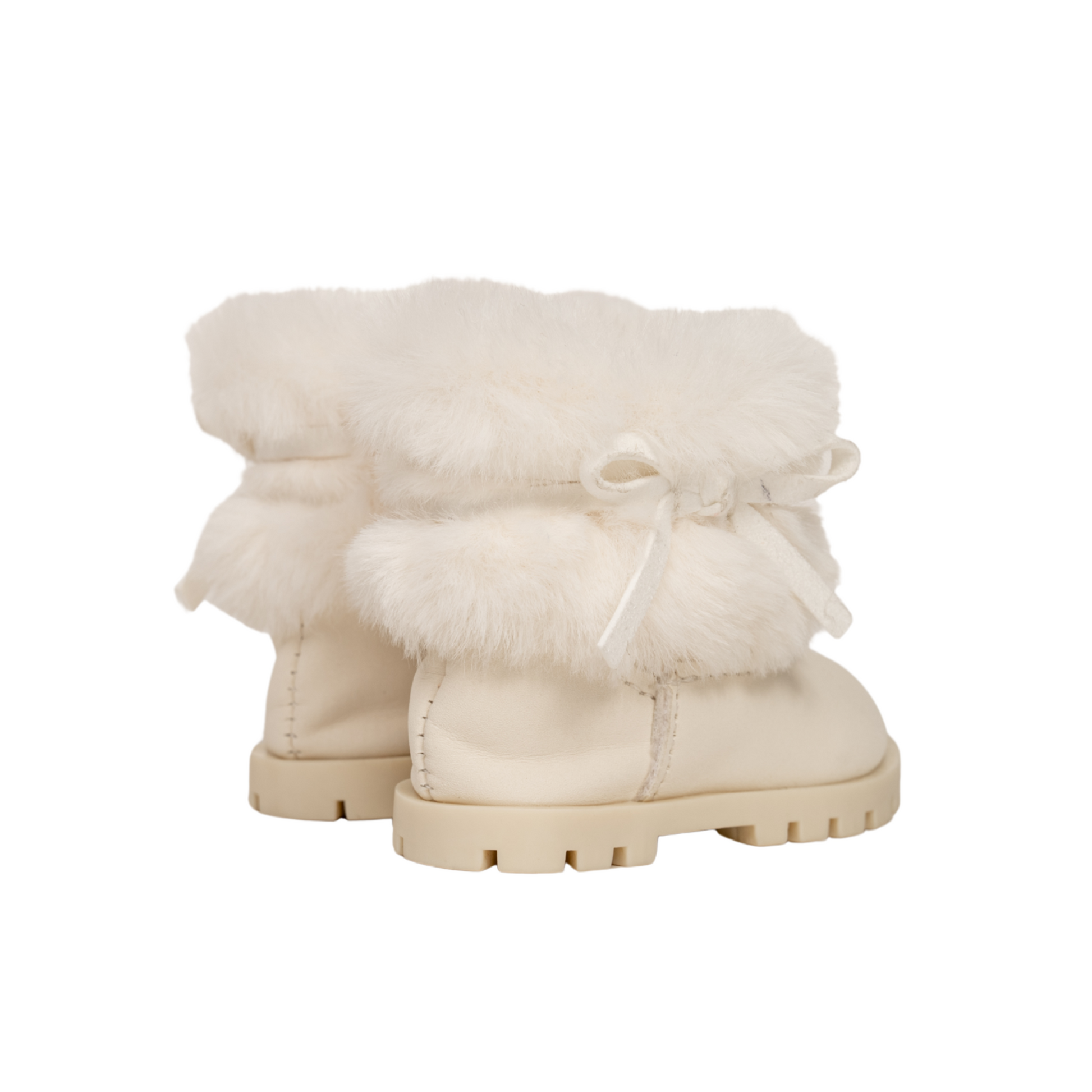 Cream furry boots with a bow for 18-inch dolls.