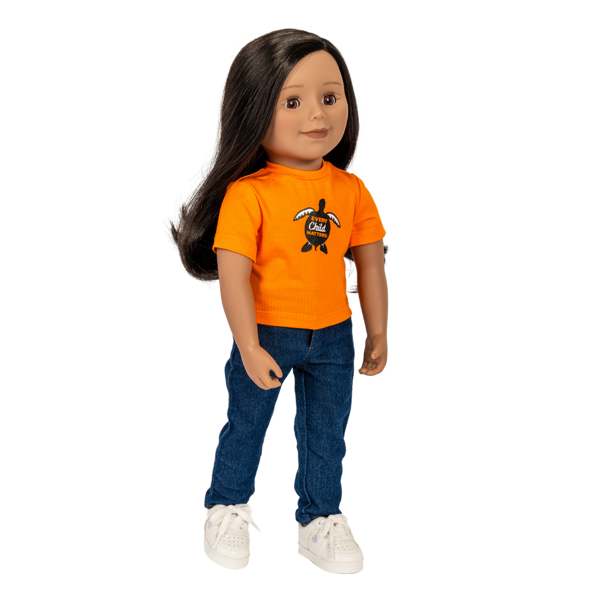 A 18" doll with long dark hair wearing an orange t-shirt with a turtle graphic, blue jeans, and white sneakers, shown against a plain white background. Maplelea