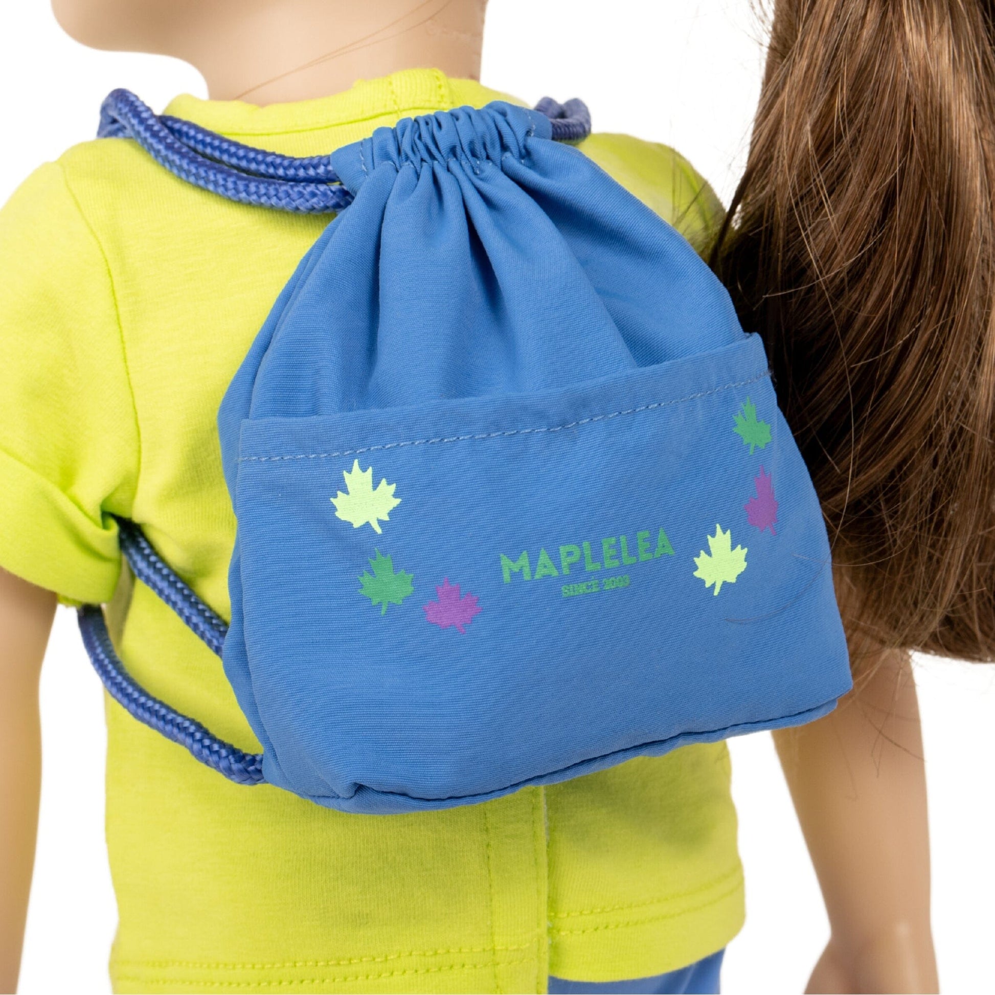 Blue drawstring backpack on back of 18" doll with Maplelea leaves graphic 