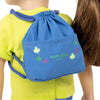 Blue drawstring backpack on back of 18" doll with Maplelea leaves graphic
