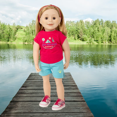 18" doll standing by lake wearing camp outfit with headband t-shirt and shorts and butterfly runners