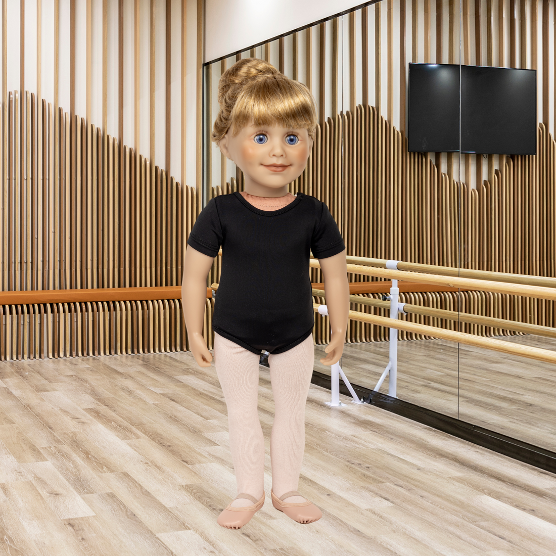18-inch doll wearing a pink ballet outfit with pink tights and black bodysuit.