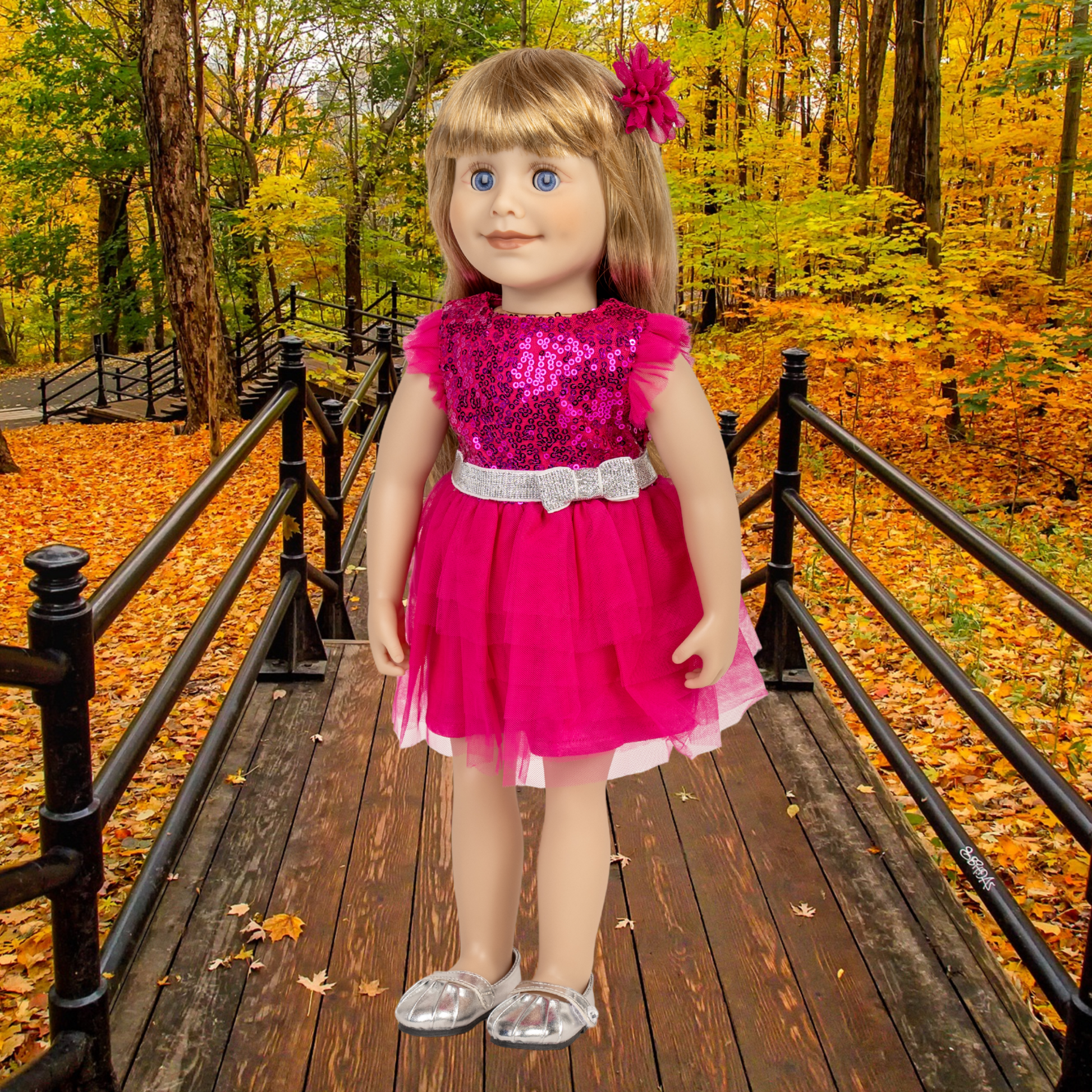 18-inch doll in a pink dress standing on a wooden bridge in an autumn forest wearing silver shine shoes.