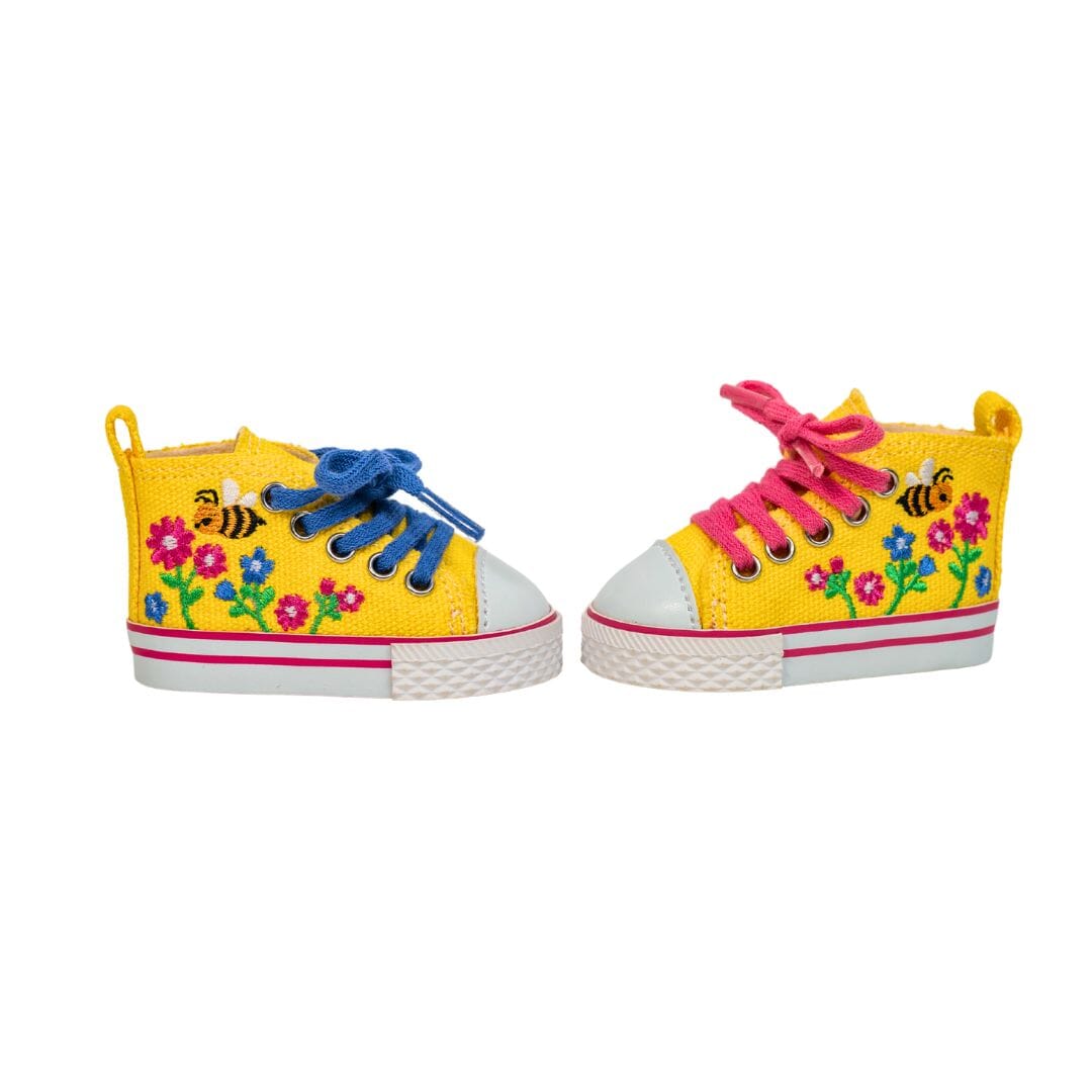 Bright yellow high top runners for dolls are embroidered with colourful flowers and buzzing bee