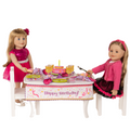 two 18-inch dolls sitting at a table wearing the gala glitz set and the belle soiree outfit