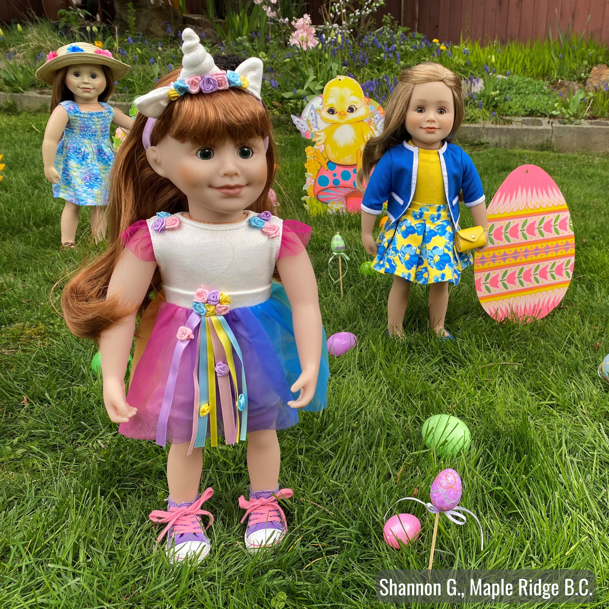 18-inch doll wearing white bodysuit colourful skirt with flowers and ribbons and a unicorn headband