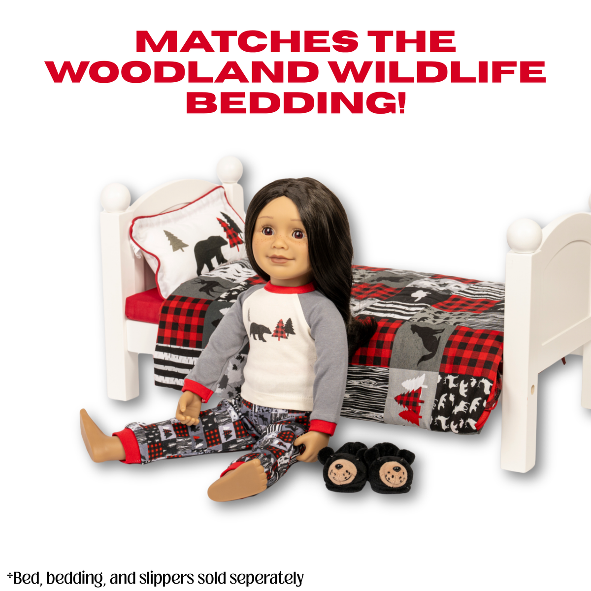 A Maplelea doll wearing a woodland-themed pajama set sits on a white bed frame with a matching red, black, and gray woodland print bedding set. The doll is also wearing black bear slippers.