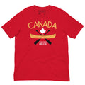 Front view of a red adult plus size T-shirt displayed on a light grey background. The shirt features a Canada-themed graphic with the word “CANADA” in gold above a white maple leaf, a gold canoe, and crossed black paddles. Below the design are the words “TRUE NORTH STRONG & FREE” in white. The shirt has short sleeves and a crew neckline.