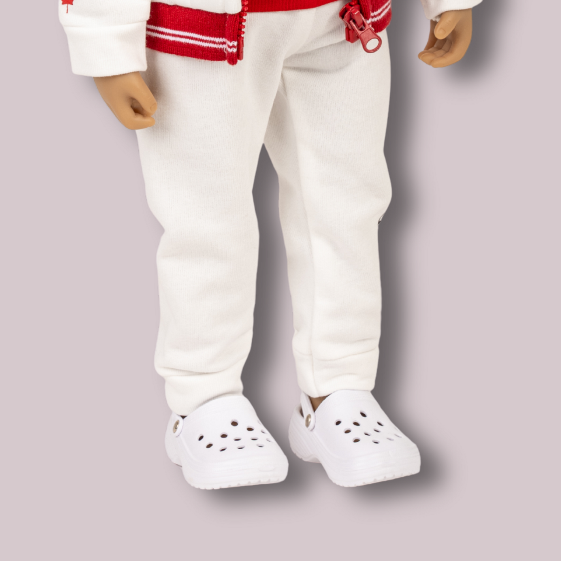 White foam clogs for 18-inch dolls with ventilation holes and heel strap on an 18-inch girl doll.