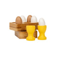 Wooden egg holder with eggs and egg cups for fun doll play.