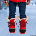 Red winter boots with sherpa lining worn by 18-inch doll on a snowy street in Montreal, Canada.