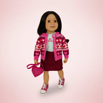 Doll wearing a pink heart-patterned jacket with a matching handbag on a white background