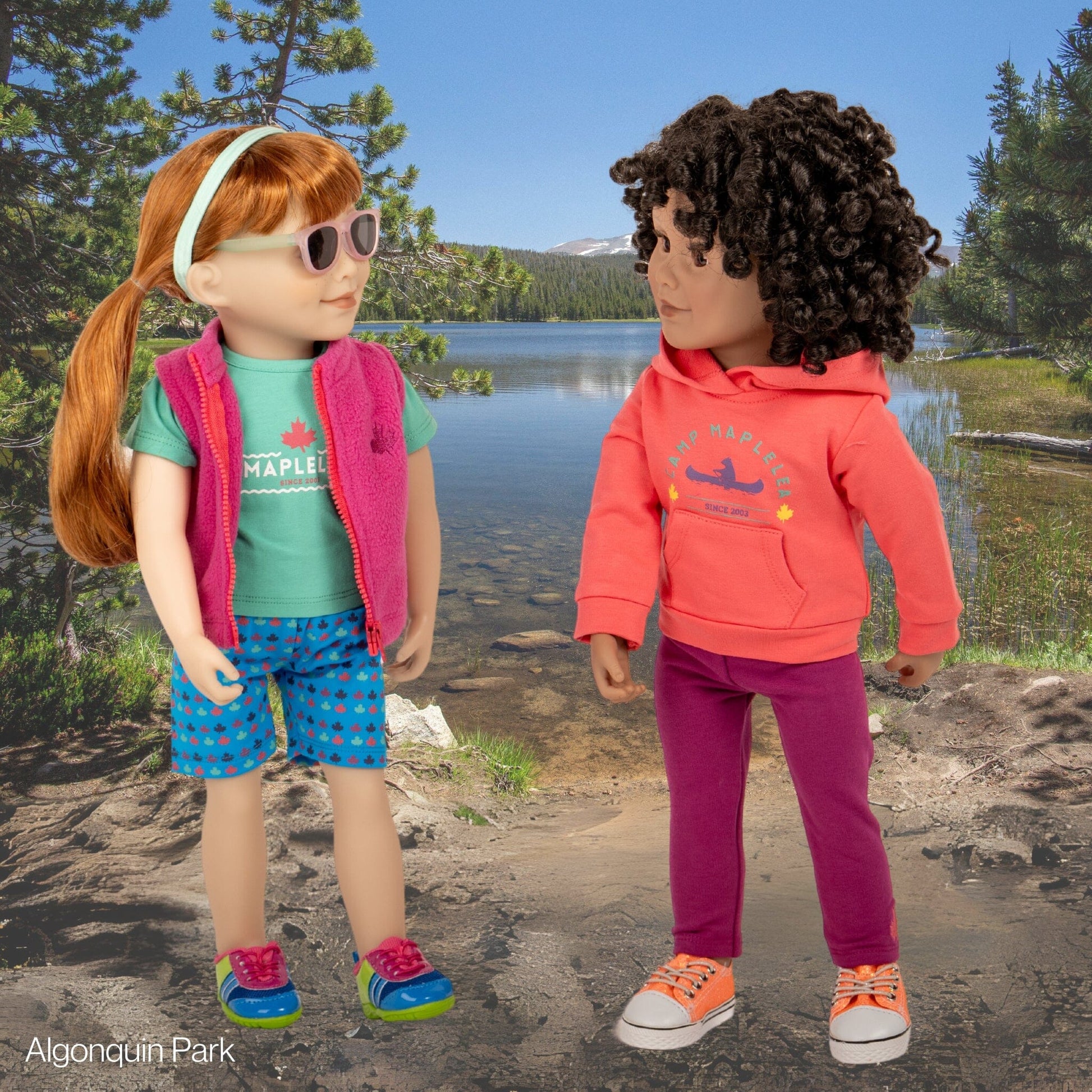 Maplelea dolls in colourful multi-piece summer campwear set and wearing accessories and shoes.