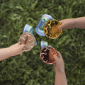 Three doll hands holding gold, silver, and bronze medals from Maplelea Canadian Girl Dolls Winner's Set.