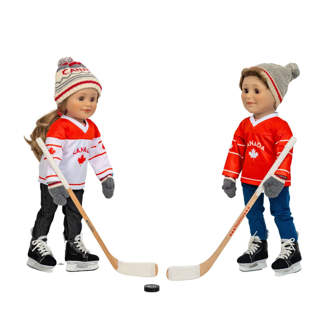 Two 18-inch dolls wearing Canadian hockey jerseys playing hockey, wearing hockey skates.