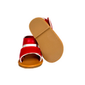 Maplelea red strappy sandals with brown soles and ankle strap for 18-inch dolls.