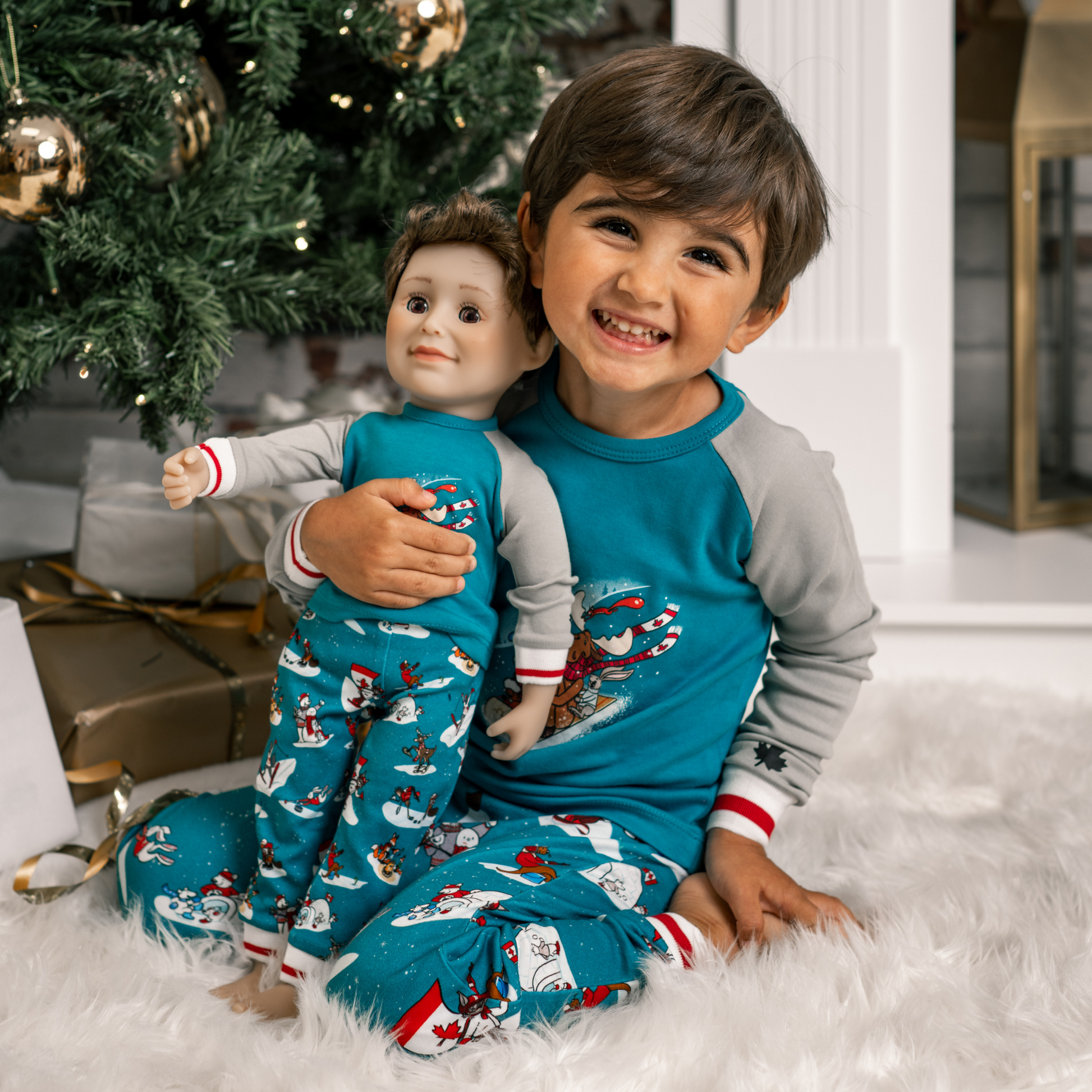 boy and boy doll wearing matching slippery slope pajamas