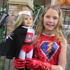 Girl dressed up as a superhero holding a doll dressed as a superhero Canadian Girl