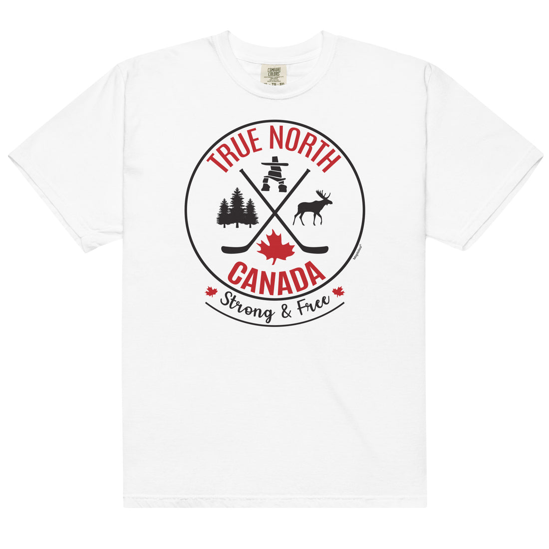 Smiling adult model wearing a white “True North Canada” graphic T-shirt, dark pants, and white sneakers, standing against a light gray background. The shirt features a circular red-and-black design with crossed hockey sticks, a maple leaf, evergreen trees, a moose, and an Inukshuk, along with the words “True North,” “Canada,” and “Strong & Free.” The model is shown walking forward, highlighting the front fit and design of the shirt.