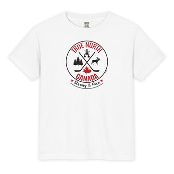 White youth T-shirt displayed on a light gray background, featuring a circular “True North Canada” graphic in red and black. The design includes crossed hockey sticks, a maple leaf, evergreen trees, a moose, and an Inukshuk, with the words “True North,” “Canada,” and “Strong & Free” arranged around the emblem.