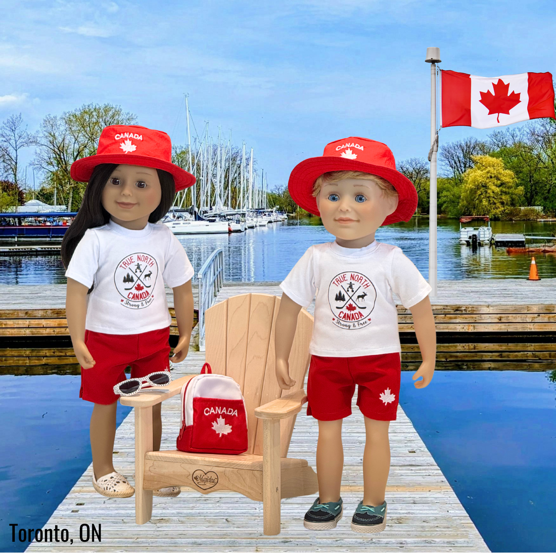 18-inch dolls wearing canadian themed red shorts, bucket hat, shirt with true north strong and free emblem, and backpack with embroidered mapleleaf.