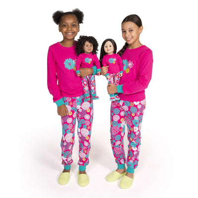 Two girls and two 18 inch dolls wearing matching pajamas from Maplelea Canadian Girl.