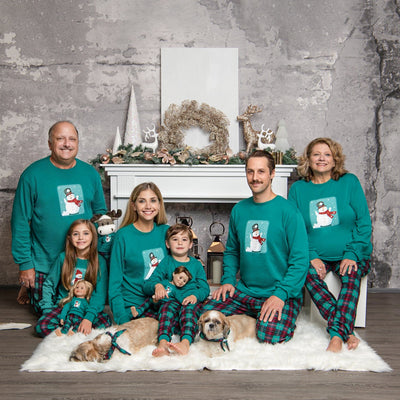Go With the Snow matching Family PJs worn by grandparents, kids, dogs and doll in holiday setting