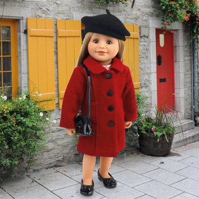 18" Canadian doll dressed in a coat with black beret, shoes, and purse on a street in Old Quebec.