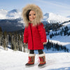 18 Inch Canadian Girl Doll wearing red winter parka and snow boots against a snowy mountain background.