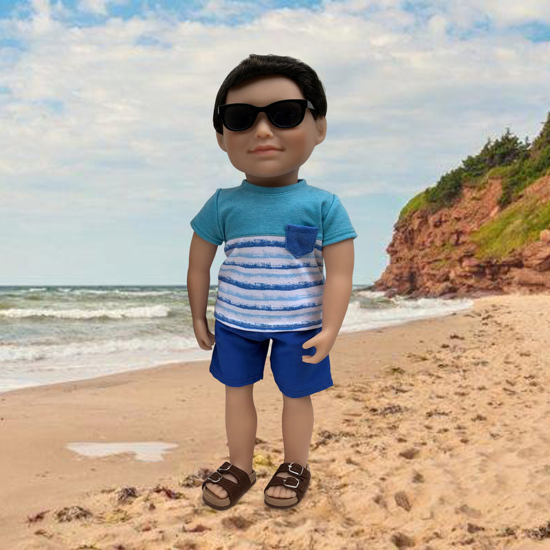 18-inch boy doll wearing tshirt, shorts, runners and sunglasses.