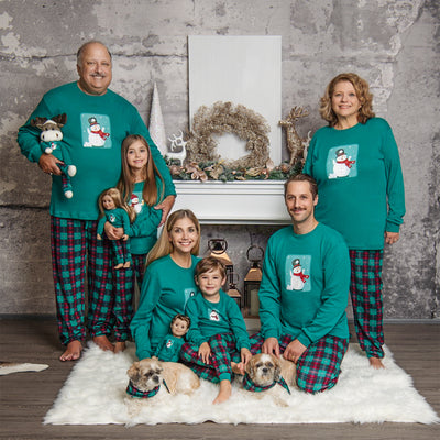 Matching Family PJs on family with grandparents, kids, dogs and doll in holiday setting