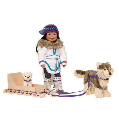 Toy Inuit dog pulling toy qamutiik, a traditional Inuit sled shown with 18 inch Inuit doll wearing an amauti.