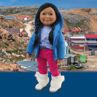 Inuit girl doll from Nunavut wearing a fuzzy hoodie, diamond imprint tshirt pink pants and mukluks against a Kimmirut backdrop.