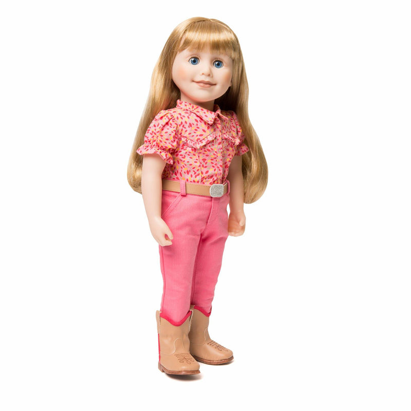 Maplelea 18 inch doll Brianne with story journal wearing pink patterned button-up shirt, pink pants, beige belt with sparkly buckle and beige riding boots. Shown in a Manitoba farm field.