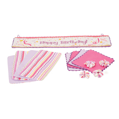 Set to Celebrate fabric pieces, including 4 pink and purple placemats, 4 patterned napkins, 4 napkin holders, and 1 bilingual birthday banner for all 18 inch dolls.