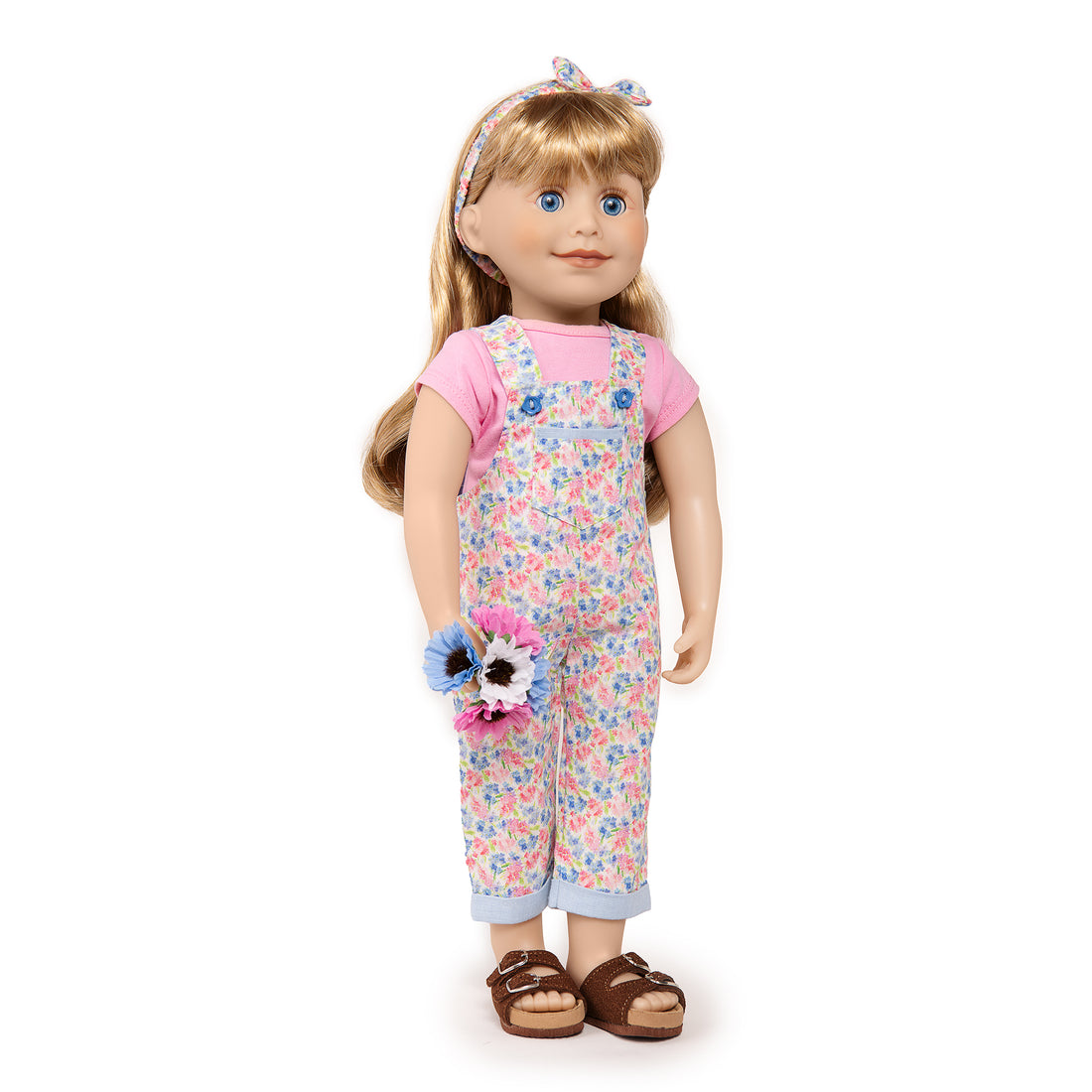 Blonde Maplelea 18 inch girl doll Brianne is wearing pink and blue overalls, hairband and tshirt.