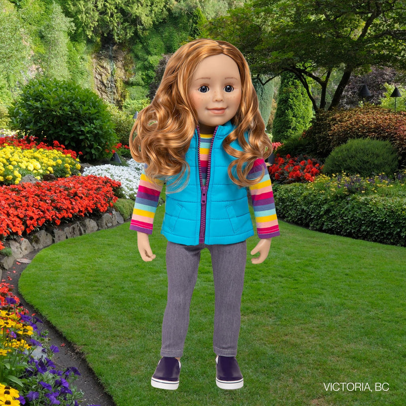 Strawberry-blonde doll from Canada wearing a blue vest and striped shirt
