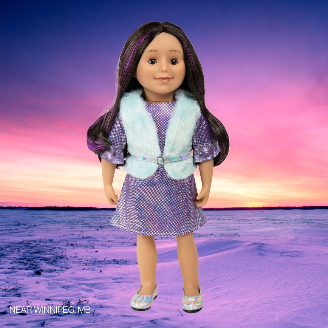 Close-up of an 18 inch doll with dark hair with purple streaks, brown eyes, plus vest and dress