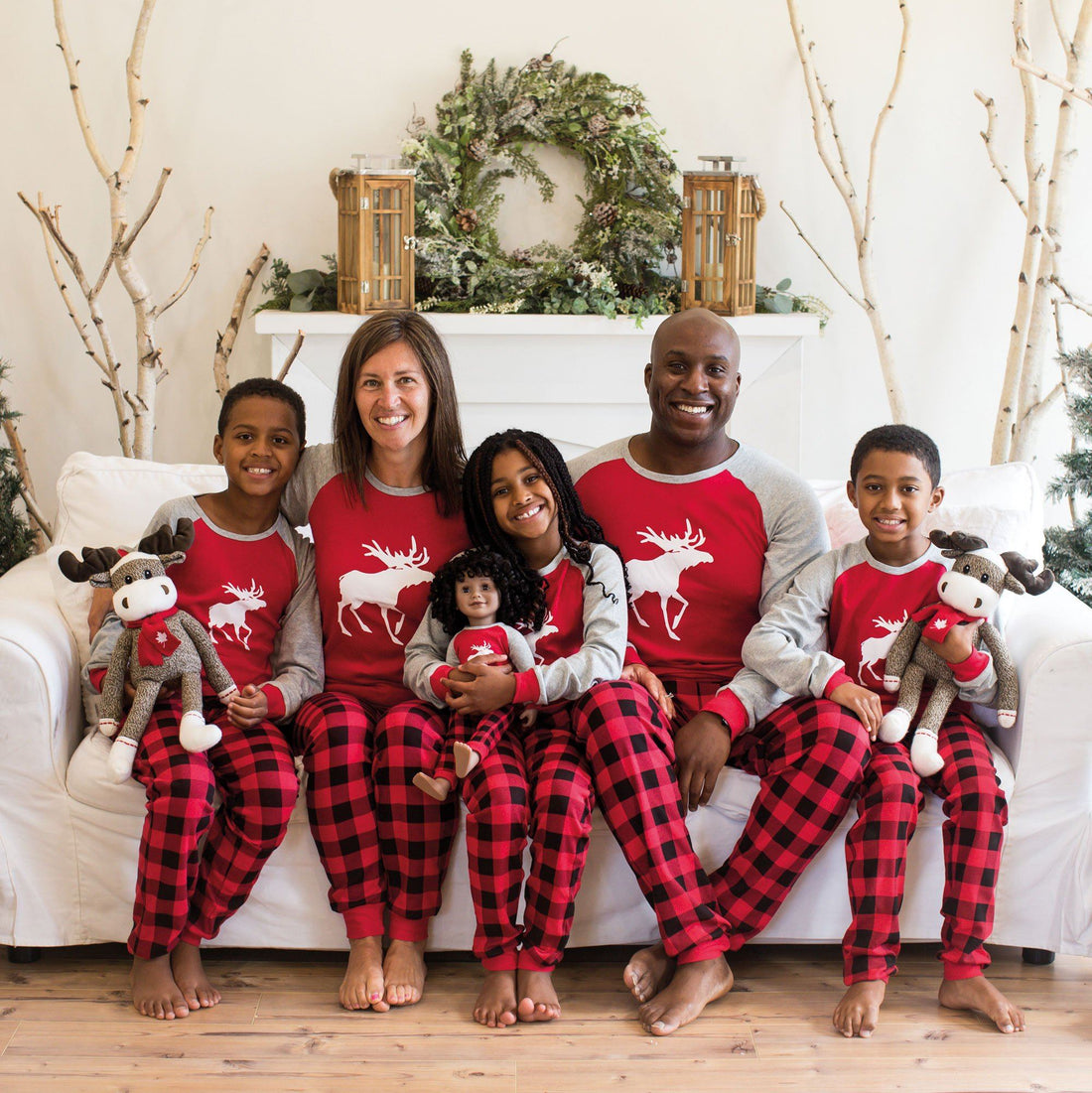 Matching red and black plaid pajamas for the whole family-adults, kids, doll and dog