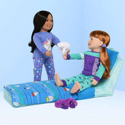 two 18-inch dolls in pajamas with a doll bed that folds up to be a doll chair